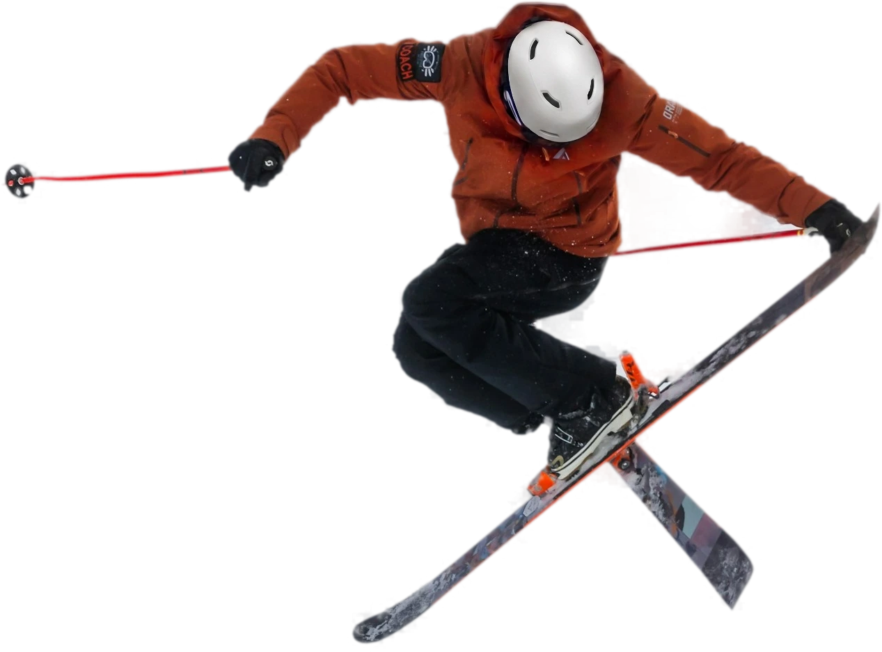 Skier in an orange jacket and white helmet mid-jump with spread skis